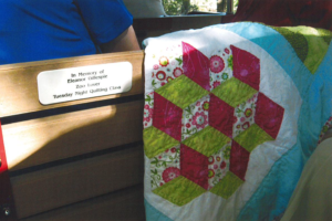 quilt on train bench with plaque