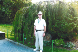 man next to willow tree