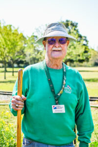 man standing holding stick