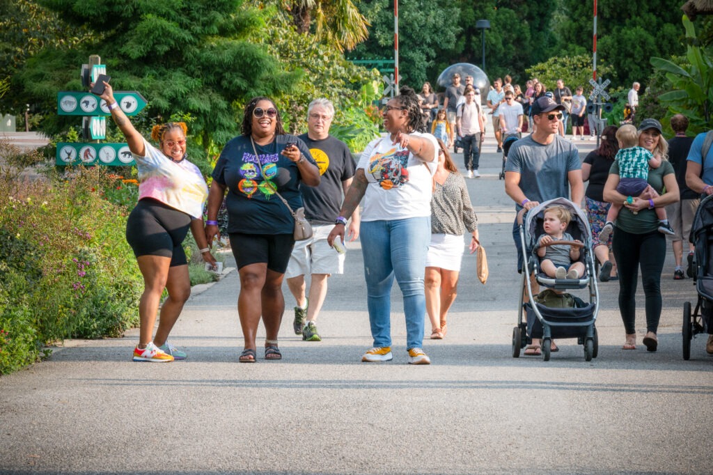 A group of people pose for a photo on a pathway at the Zoo